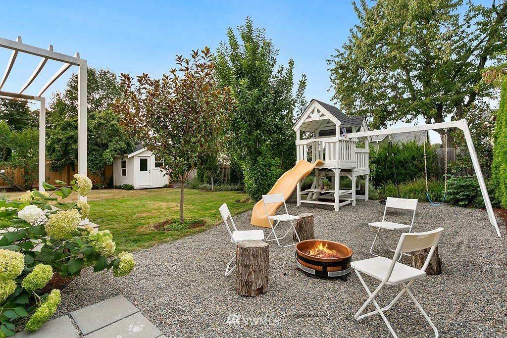 1102 North 30th Street Renton, WA 98056 - Photo 34 of 38 a view of a patio with table and chairs potted plants with wooden floor and fence