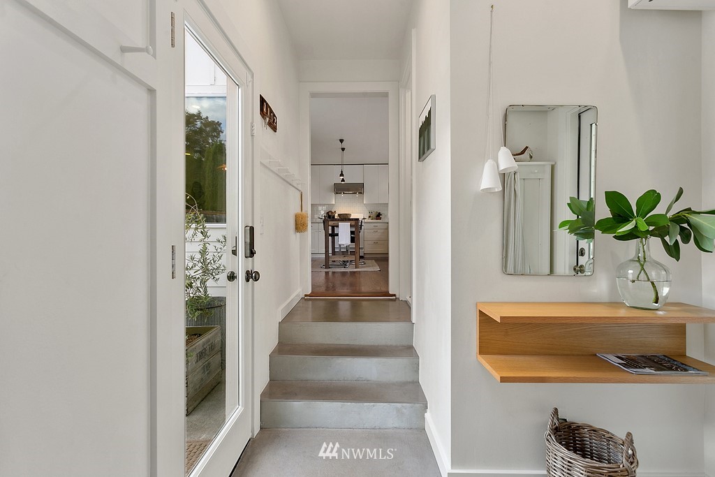 1102 North 30th Street Renton, WA 98056 - Photo 7 of 38 a hallway with a dining table and chairs
