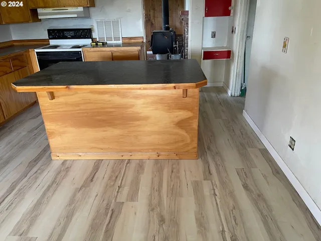a kitchen with a sink appliances cabinets and a window