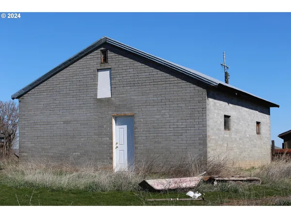 a black and white building with a yard