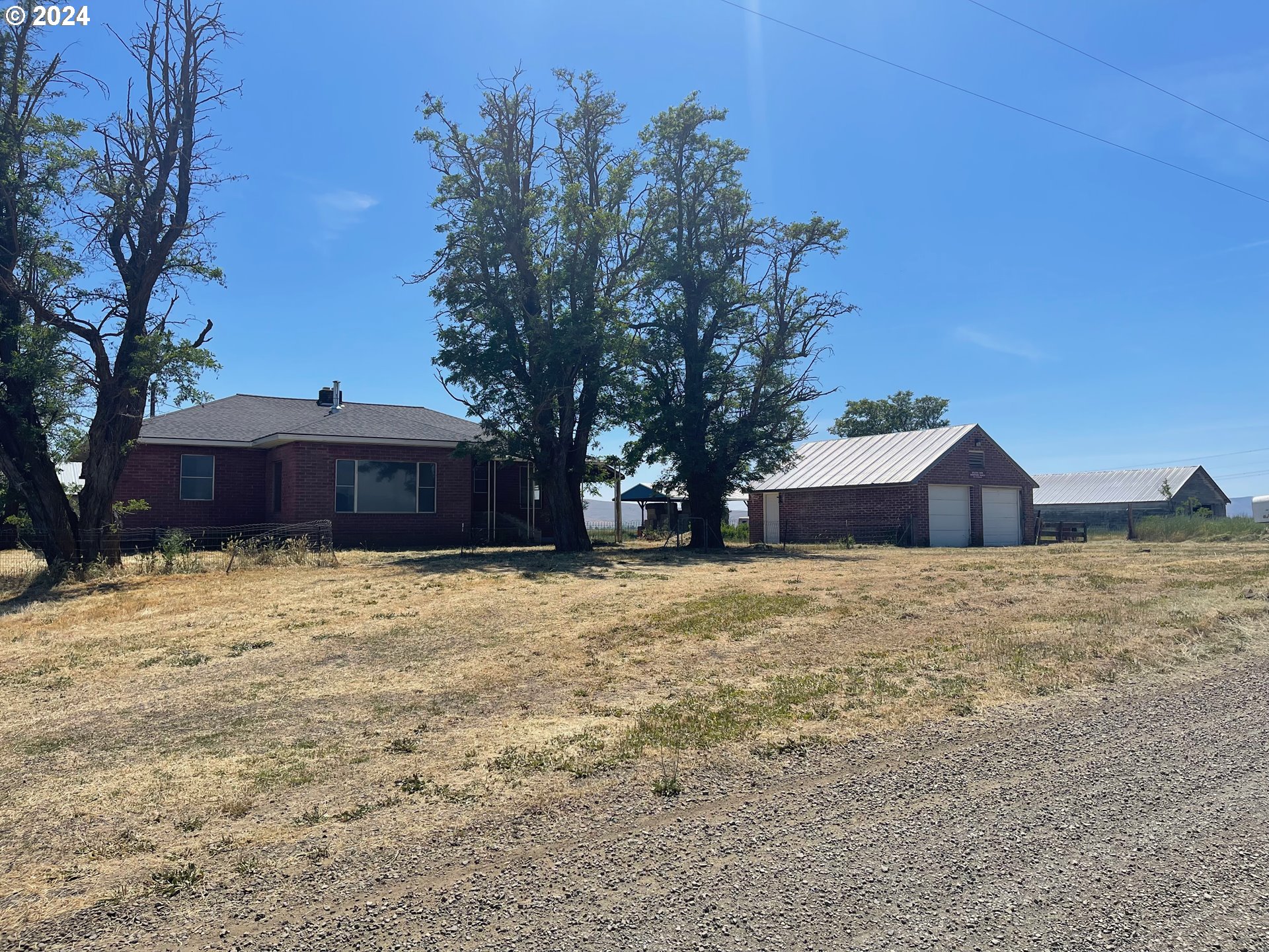 242 Van Hoy Road Goldendale, WA 98620 - Photo 7 of 44 a front view of house with yard and trees