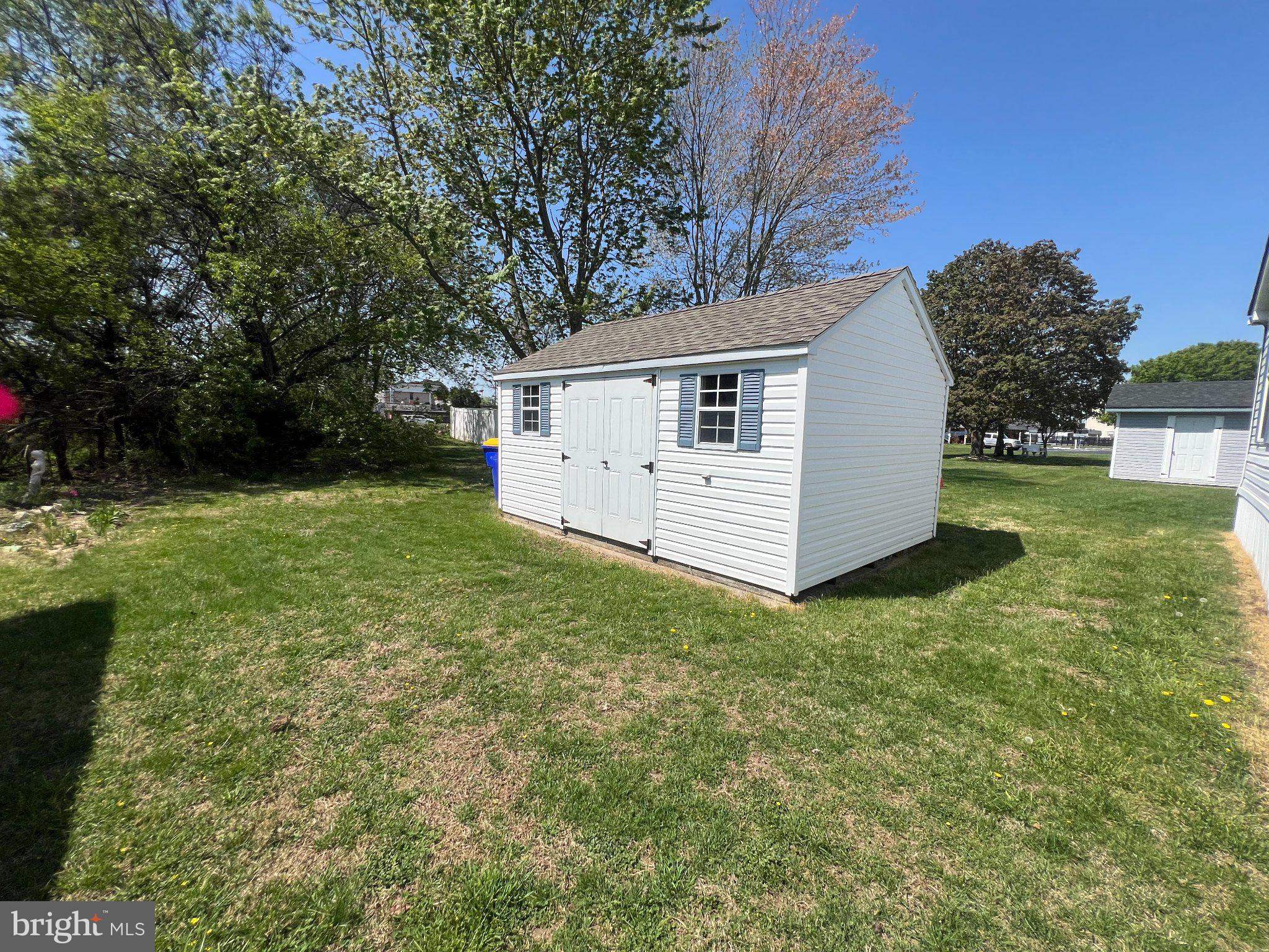 7 Colonial Lane Rehoboth Beach, DE 19971 - Photo 3 of 18 Charming garden shed in lush greenery.