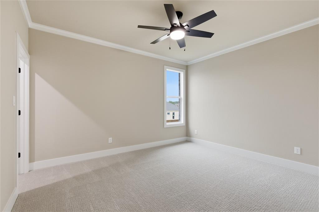 702 Anne Road Van Alstyne, TX 75495 - Photo 21 of 27 Carpeted room featuring a single window, crown molding, and a ceiling fan with integrated lighting