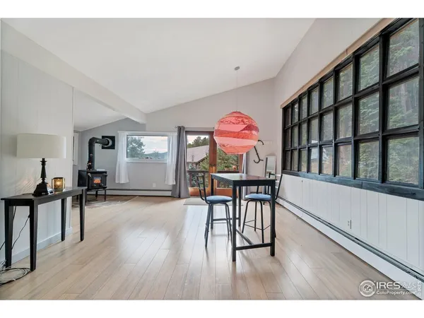 a view of a room with furniture and wooden floor