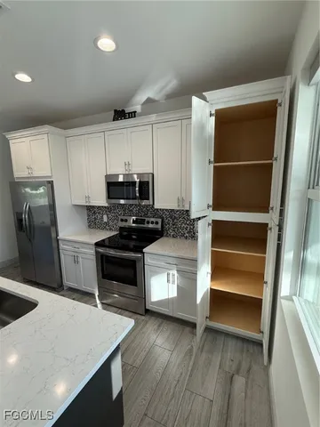 a kitchen with wooden cabinets and a stove top oven