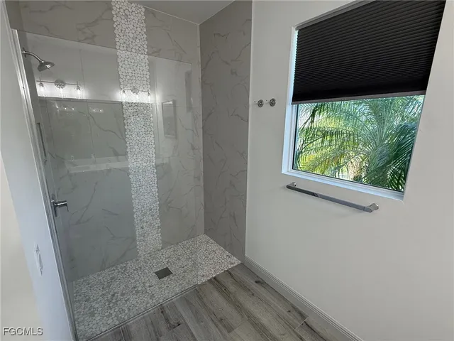 a bathroom with a toilet and a shower