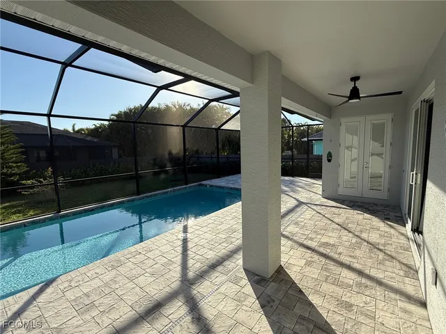 a backyard of a house with table and chairs
