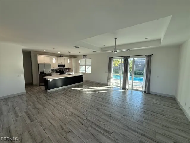 a view of kitchen with wooden floor and windows
