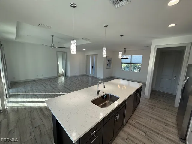a kitchen with a sink a counter top space and stainless steel appliances