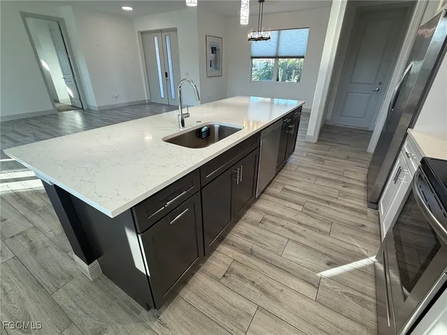 a kitchen with a sink stove and cabinets