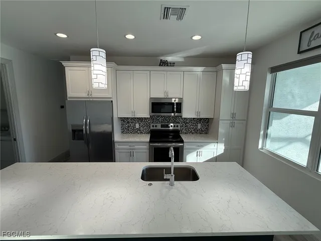 a kitchen with a refrigerator and a microwave