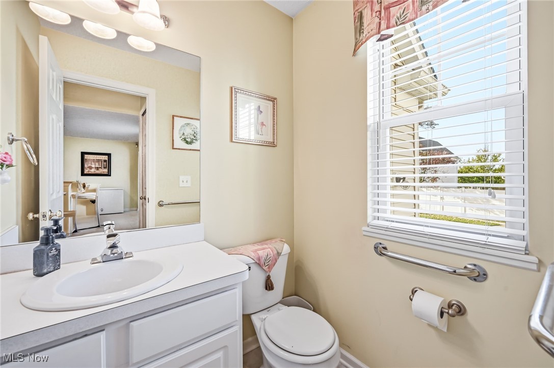 4420 Archer Road Cleveland, OH 44105 - Photo 4 of 18 Half bath on 1st floor featuring toilet and vanity