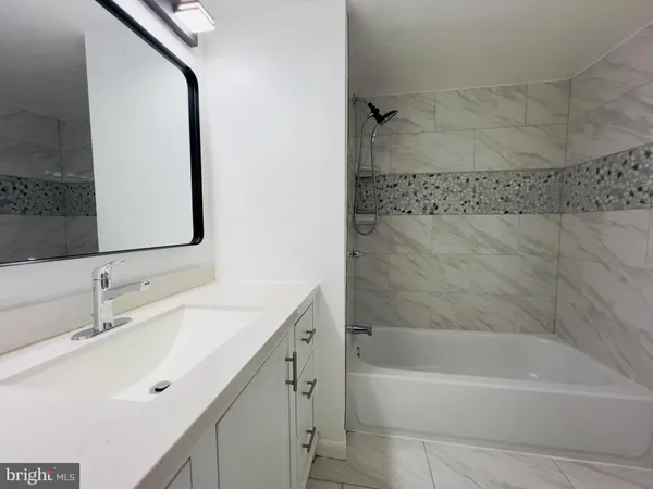 a bathroom with a bathtub and a sink