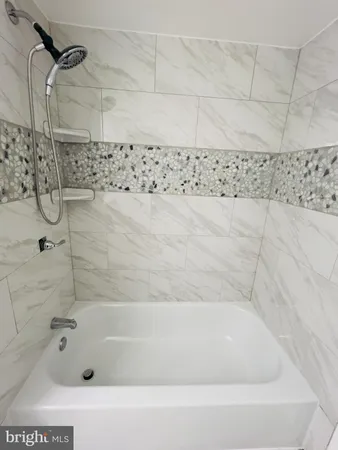 a bathroom with a bathtub and shower