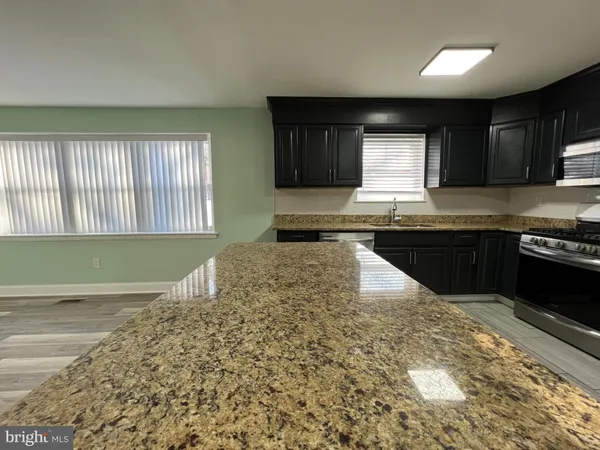 a kitchen with a stove a sink and a microwave