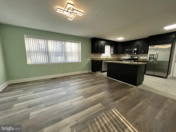 a view of kitchen with sink and microwave