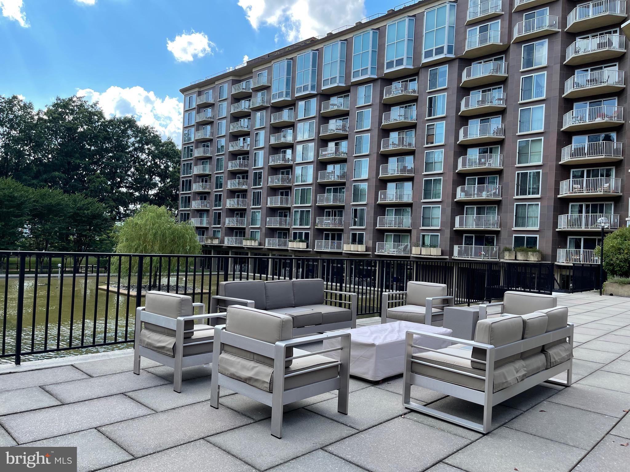520 N Street Southwest, Unit S317 Washington, DC 20024 - Photo 47 of 74 a roof deck with couches and potted plants