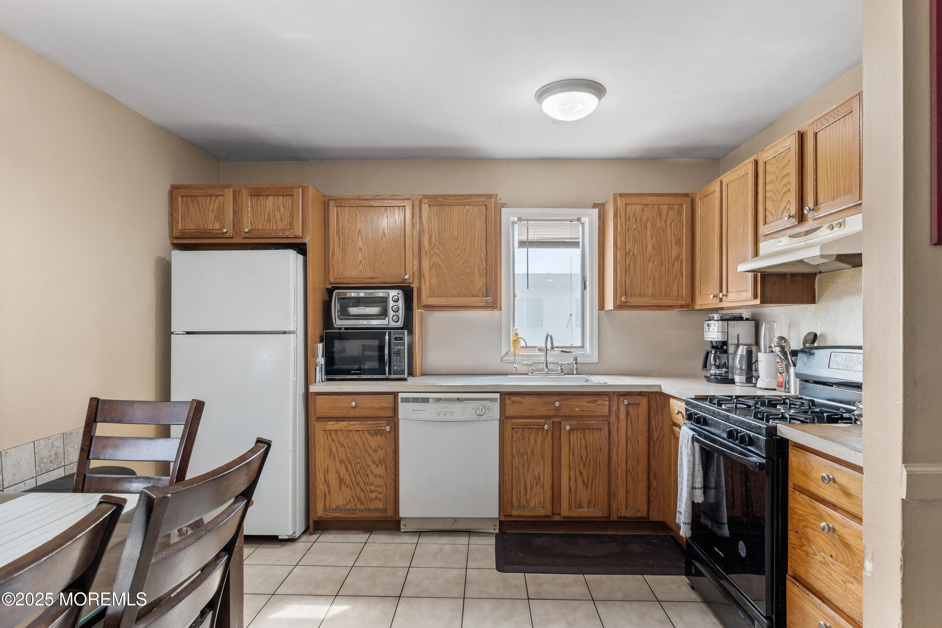 517 14th Avenue Belmar, NJ 07719 - Photo 17 of 31 a kitchen with stainless steel appliances granite countertop a stove top oven a refrigerator a sink and a microwave