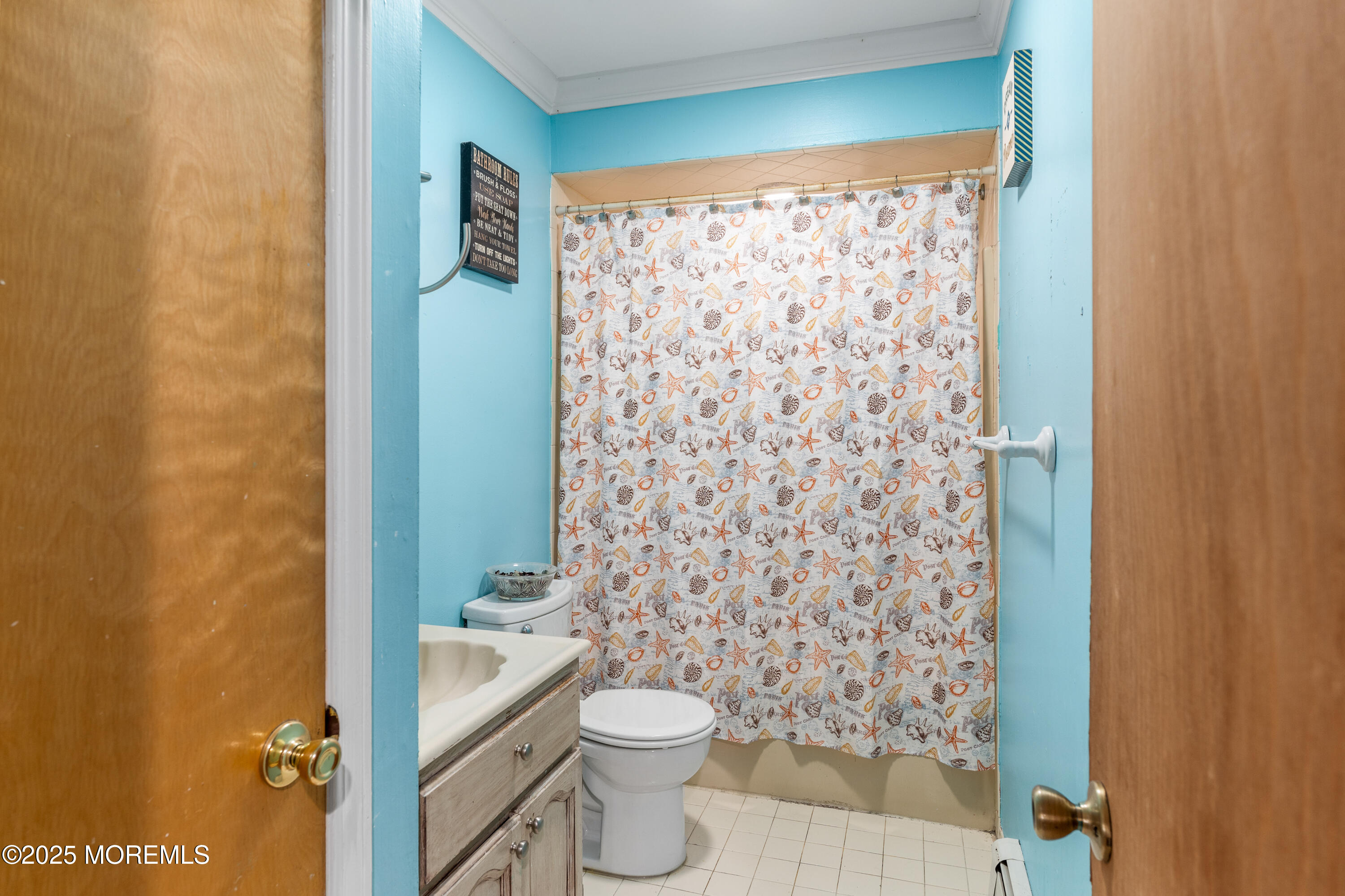 517 14th Avenue Belmar, NJ 07719 - Photo 20 of 31 a bathroom with a toilet and a shower curtain