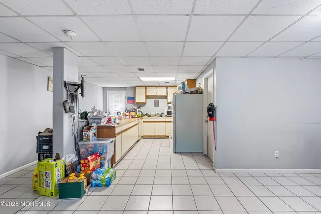 a view of kitchen with furniture and refrigerator