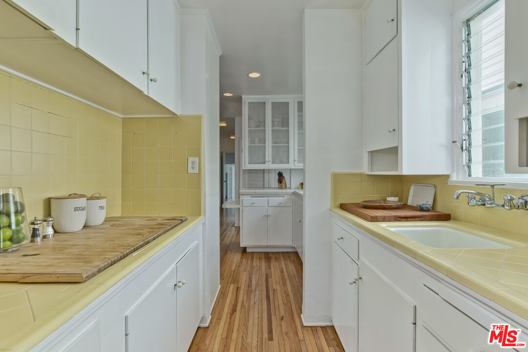 23350 Malibu Colony Road, Unit 109 Malibu, CA 90265 - Photo 12 of 61 a kitchen with a sink stove and cabinets