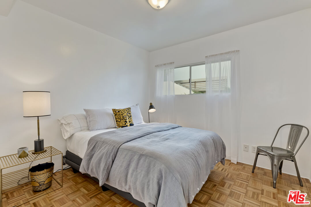 23350 Malibu Colony Road, Unit 109 Malibu, CA 90265 - Photo 17 of 61 a bedroom with a bed and chair