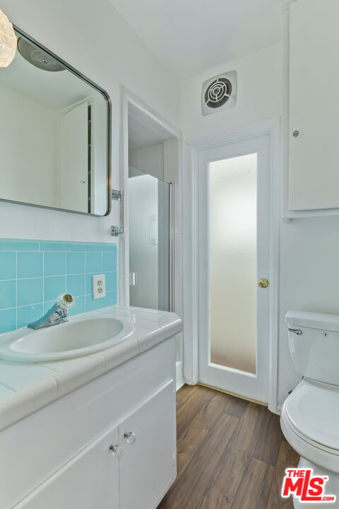 23350 Malibu Colony Road, Unit 109 Malibu, CA 90265 - Photo 18 of 61 a bathroom with a toilet sink and mirror