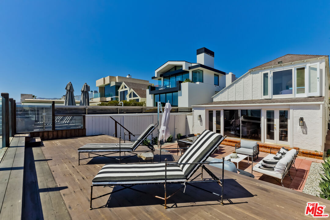 23350 Malibu Colony Road, Unit 109 Malibu, CA 90265 - Photo 29 of 61 a view of a patio with a table and chairs