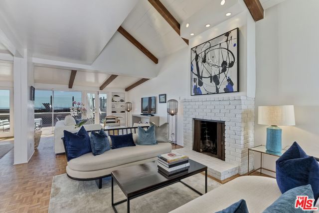 a living room with furniture a rug and a large window