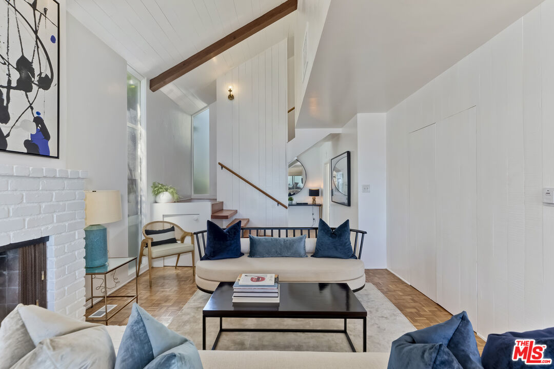 23350 Malibu Colony Road, Unit 109 Malibu, CA 90265 - Photo 37 of 61 a living room with furniture and a fireplace