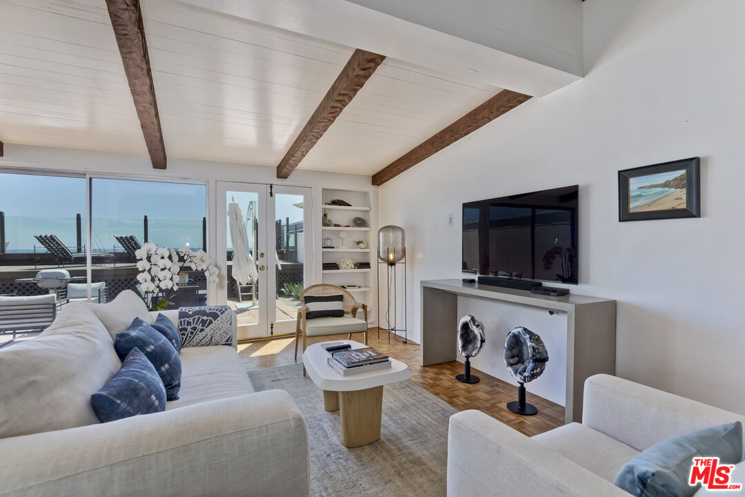 23350 Malibu Colony Road, Unit 109 Malibu, CA 90265 - Photo 38 of 61 a living room with furniture and a flat screen tv