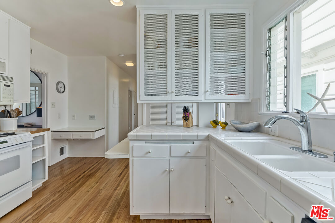 23350 Malibu Colony Road, Unit 109 Malibu, CA 90265 - Photo 45 of 61 a kitchen with a sink cabinets and window