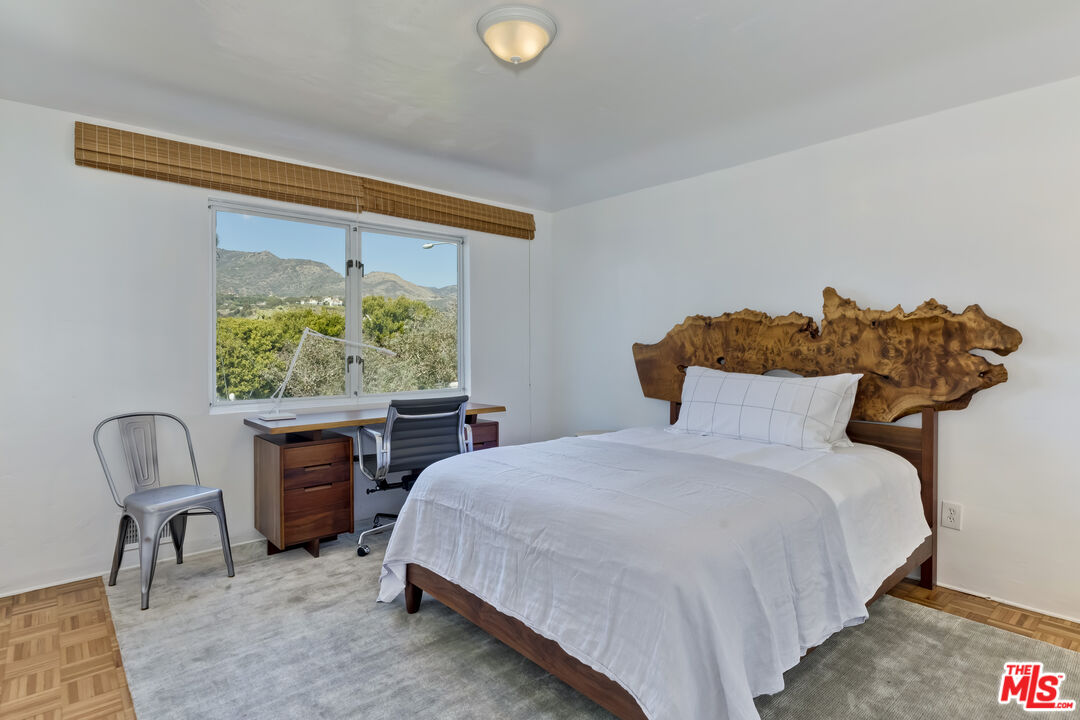 23350 Malibu Colony Road, Unit 109 Malibu, CA 90265 - Photo 54 of 61 a bedroom with a bed and a chair