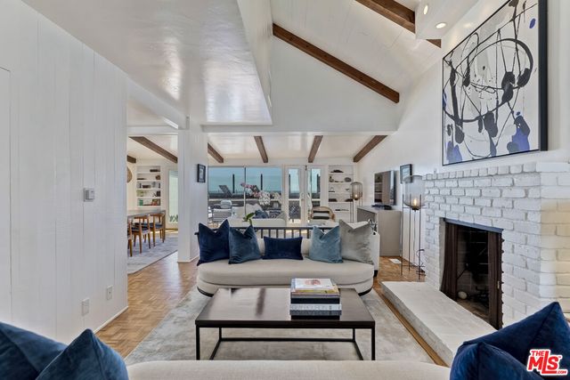 a living room with furniture and kitchen view
