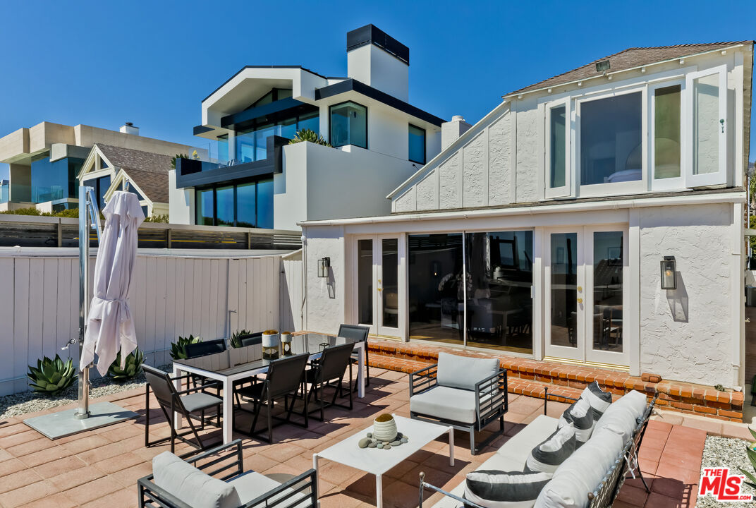 23350 Malibu Colony Road, Unit 109 Malibu, CA 90265 - Photo 61 of 61 a view of a patio with couches table and chairs and potted plants