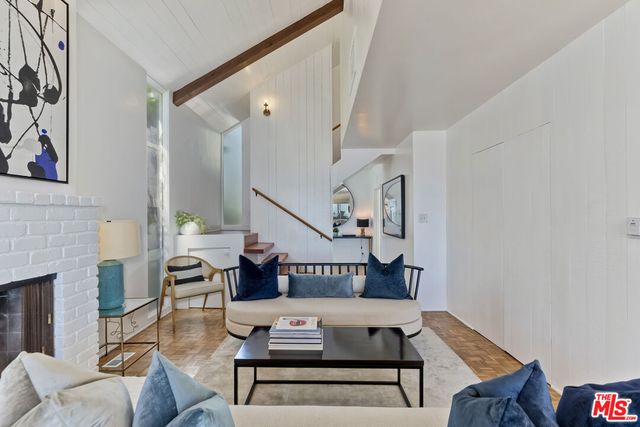 a living room with furniture a rug and a large window