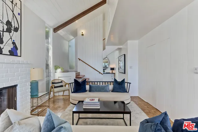 a living room with furniture a rug and a large window