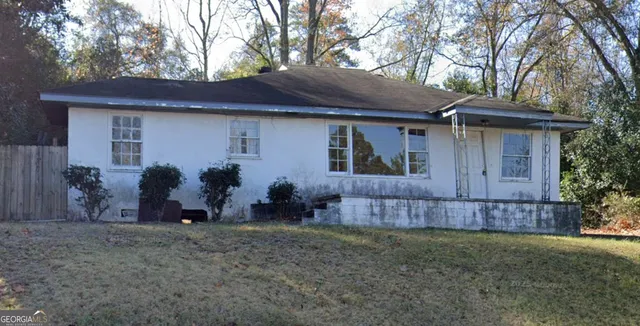 a backyard of a house with plants and trees