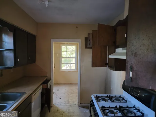 a kitchen with a sink stove and refrigerator