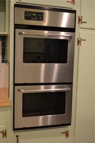 a stove top oven sitting inside of a kitchen