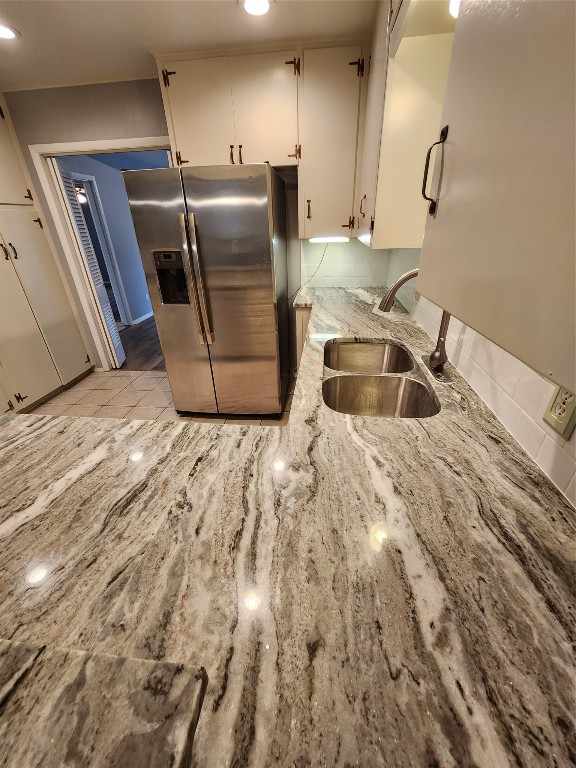 1912 Ridgemont Drive Austin, TX 78723 - Photo 16 of 28 a kitchen with granite countertop a sink and a refrigerator