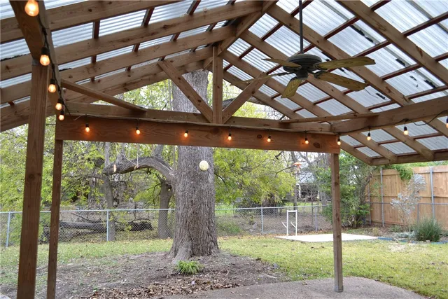 a backyard of a house with barbeque oven and brick wall