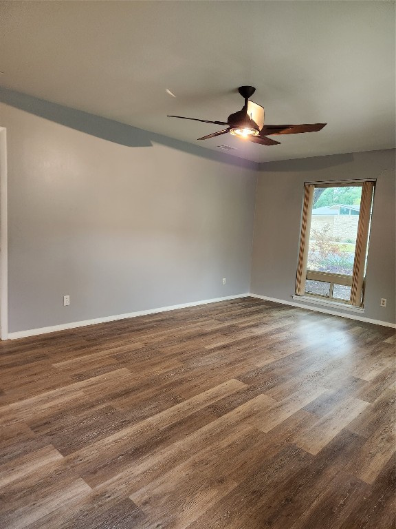 1912 Ridgemont Drive Austin, TX 78723 - Photo 7 of 28 an empty room with wooden floor chandelier and windows