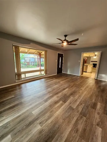wooden floor in an empty room with a window