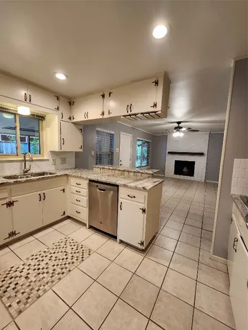 a kitchen with a stove top oven cabinets and appliances