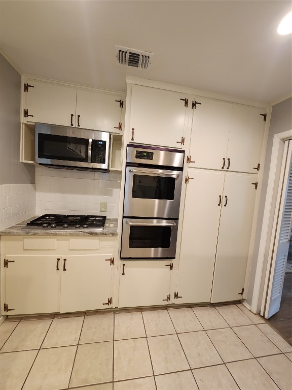1912 Ridgemont Drive Austin, TX 78723 - Photo 10 of 28 a kitchen with cabinets and steel stainless steel appliances