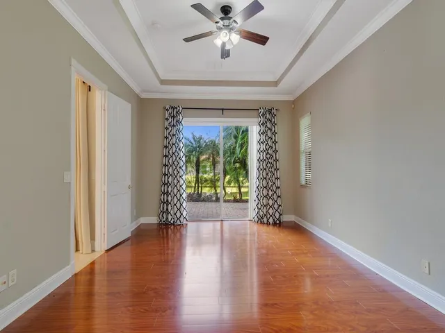 a bathroom with a granite countertop sink a large mirror and a toilet