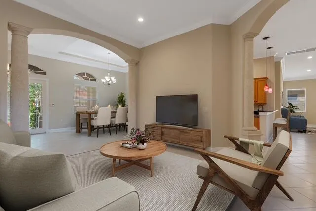 a dining room with furniture a chandelier and window