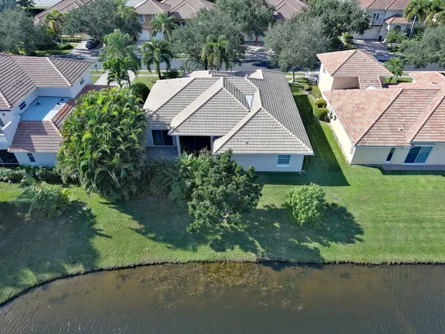 an aerial view of a house with a yard and trees
