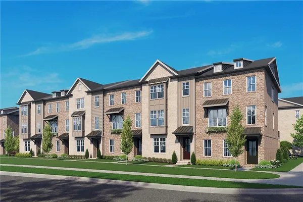 a front view of a residential apartment building with a yard